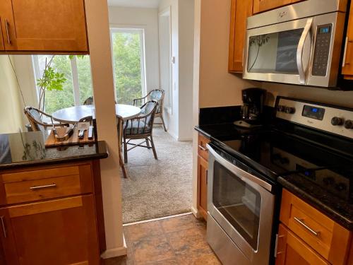 a kitchen with a stove and a microwave at Starfish Point in Newport