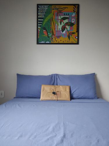 a bag sitting on top of a bed at Casa Amarela Hostel in Barão de Cocais