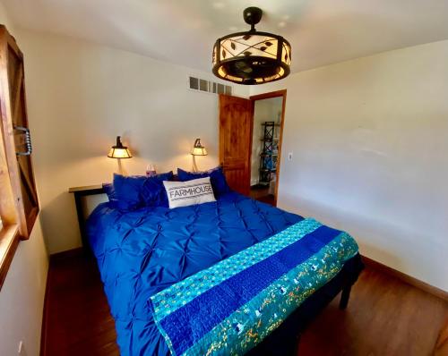 a bedroom with a blue bed with a blue comforter at The Farmhouse ranch in Stockton