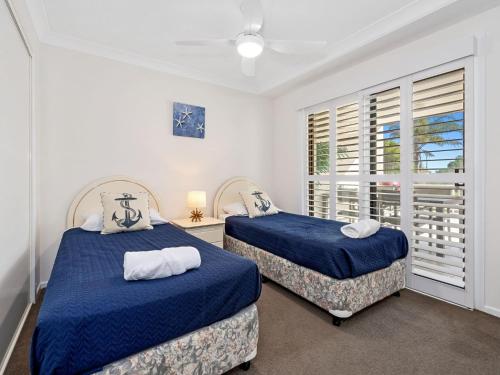 a bedroom with two beds and a window at Ocean Outlook on Marine Parade in Kingscliff