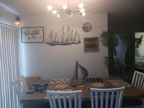 a dining room with a table with a boat on the wall at Turtles Nest of Port Orange in Port Orange