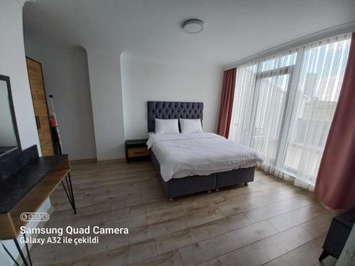 a bedroom with a bed and a large window at pointrezidans in Ankara