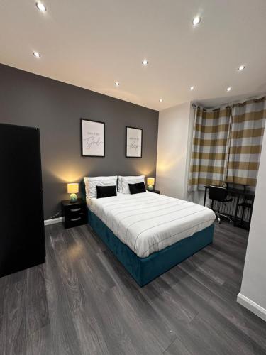 a bedroom with a large bed and a table at Tranquil Oasis in Gravesend, Kent in Northfleet