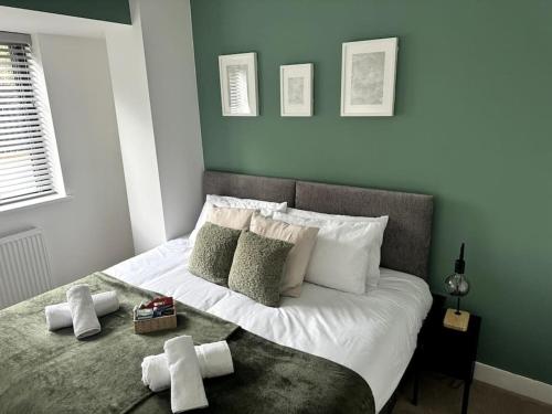 een slaapkamer met een bed met handdoeken erop bij Luxury Oaks Suite, Free private parking, 2 Bed 2 Bathroom Apartment, Central location in Birmingham