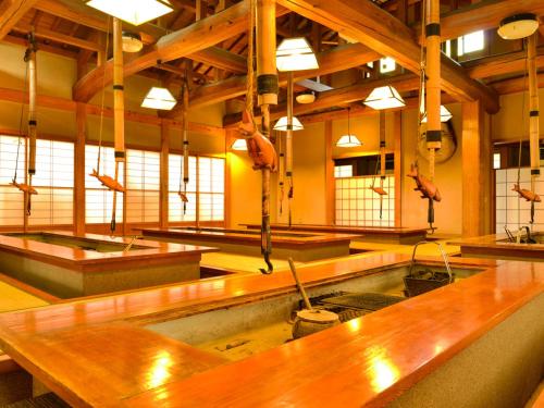 a large room with many tables in a building at Fudouonsen Sawaya in Shimojo mura