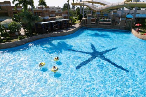 a large swimming pool with a water slide at Saipan World Resort in Susupe