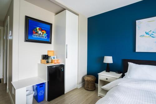 a bedroom with a bed and a blue wall at Crawford View in Kelowna