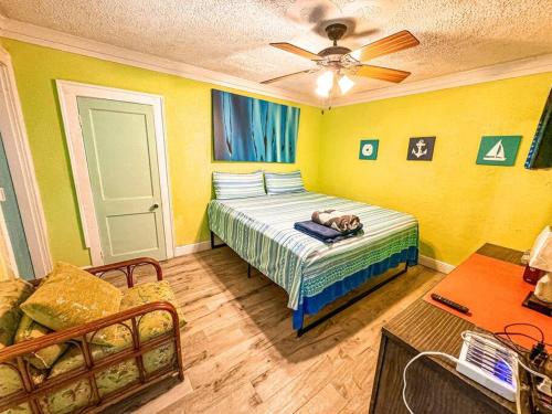a bedroom with a bed and a ceiling fan at COMPLIMENTARY CAR! Casa Del Mar! in Nassau