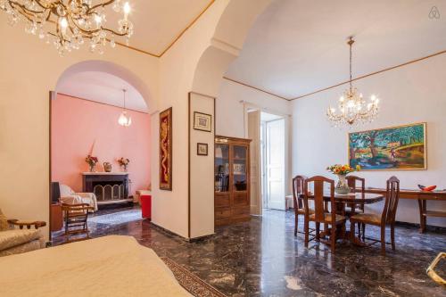 a dining room and living room with a table and chairs at Casa Vacanze Casa Ida in Cava deʼ Tirreni