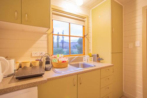 a kitchen with a sink and a window at Villa City Break for couples 27 mins CHC Airport in Christchurch
