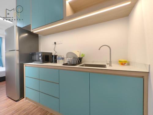 a kitchen with blue cabinets and a sink at K Avenue Modern Style Studio (5 Mins to Airport) in Kota Kinabalu
