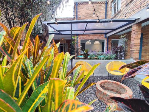 a garden with chairs and plants in front of a building at Trip Monkey Chapinero in Bogotá