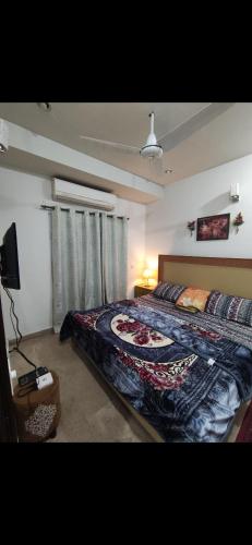 a bedroom with a bed and a television in it at 1 bhk appartment available in al qasimia in Sharjah