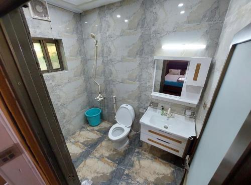 a bathroom with a toilet and a sink and a mirror at 1 bhk appartment available in al qasimia in Sharjah