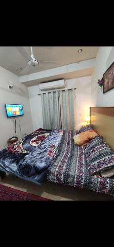 a bedroom with a bed with a blanket on it at 1 bhk appartment available in al qasimia in Sharjah