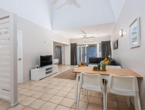 a living room with a table and a couch at Hastings Cove Holiday Apartments in Hastings Point