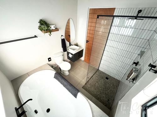 a bathroom with a toilet and a glass shower at The Clarens House in Clarens