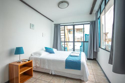 a bedroom with a bed and a window at Maidith Galapagos Inn in Puerto Ayora