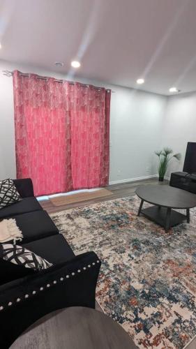 a living room with a couch and a table at Comfy one bedroom Airdrie in Airdrie