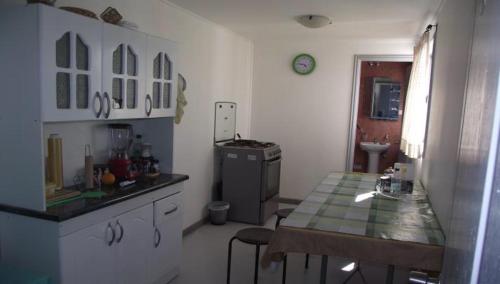 a kitchen with a table and a counter top at HOSTAL DIEGO DE ALMAGRO in Diego de Almagro