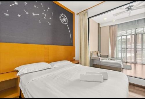 a bedroom with a large white bed and a window at Cthomestay @ nova highland hotel in Brinchang