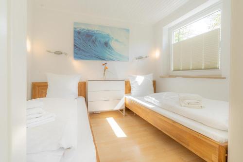 a bedroom with two beds and a window at Wohnung-A-303 in Böhl