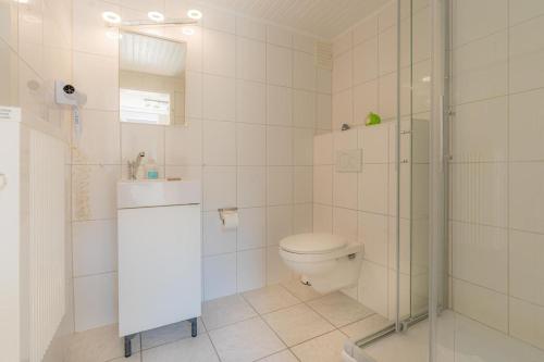 a bathroom with a toilet and a glass shower at Wohnung-A-303 in Böhl