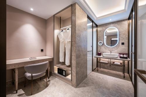 a bathroom with a sink and a mirror at Mercure Beijing Downtown in Beijing