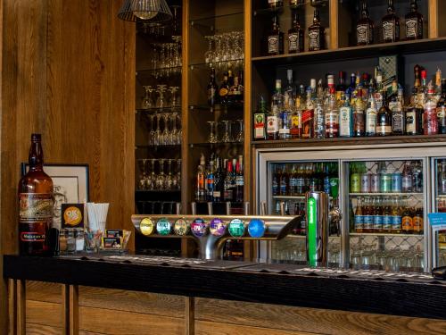 a bar with a lot of bottles of alcohol at Paroa Hotel in Greymouth