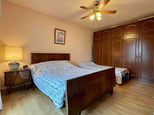 a bedroom with a bed and a ceiling fan at Appartement 2 pièces avec parking près de la plage - FR-1-246A-295 in Saint-Georges-dʼOléron