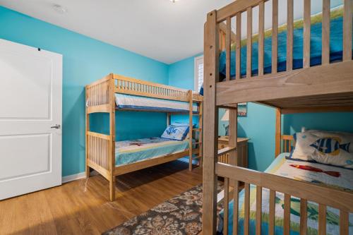 1 dormitorio con 2 literas y paredes azules en Island Breeze 120A en Virginia Beach