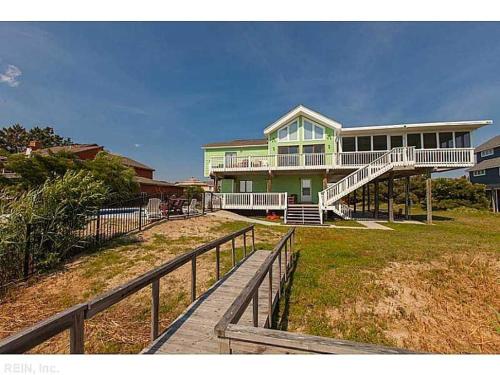 a large house with a boardwalk in front of it at A Free Spirit in Virginia Beach