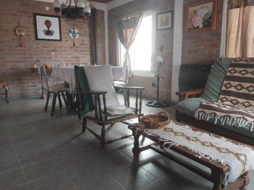 a living room with a couch and a table at Caleta del Sur in Las Grutas