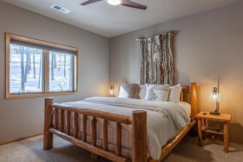 a bedroom with a large bed with a window at Beautiful Mountain Modern Home 4Bedroom Spa in Whitefish