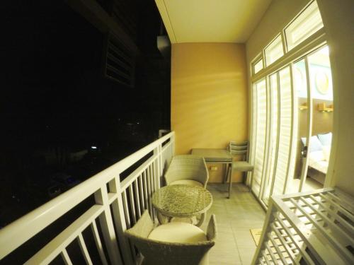 a balcony with a table and chairs in a room at Pico De Loro room Jacana A Bldg. in Nasugbu