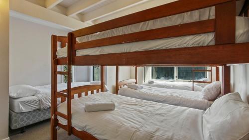 a bedroom with two bunk beds and a window at 1-8 Hot Plate in Mount Hotham