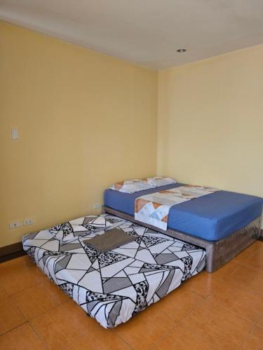 two beds sitting next to each other in a room at Astra Bella Apartment - Unit 4 in Dumaguete