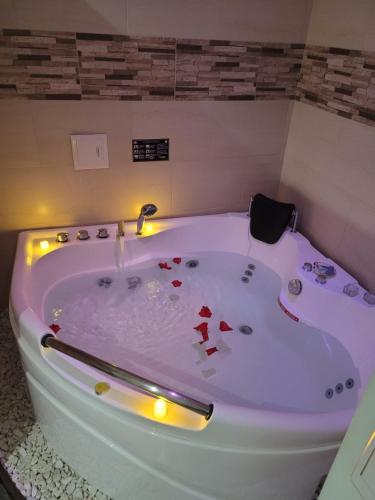 una vasca da bagno bianca con cuori rossi di Hotel Ocean Fusagasuga a Fusagasugá