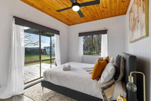 a bedroom with a bed and a ceiling fan at The Hildeton on Hogans in Yarrawonga