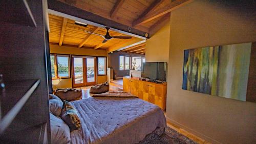 a large room with a bed and a television at Panoramic Ocean sunset Views with Heated Pool & Spa best location in San Diego