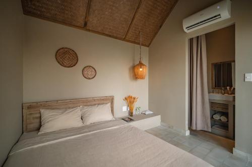 a bedroom with a white bed and a window at Life Club Beach Resort in Quy Nhon