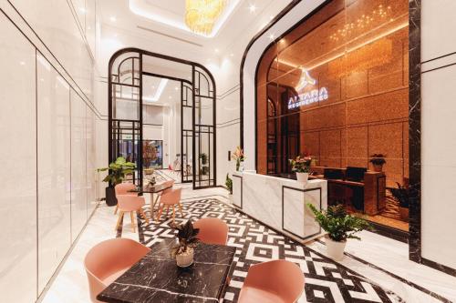 a lobby of a store with a table and chairs at Altara Quy nhơn Residences Wins in Quy Nhon