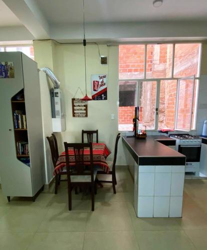 a kitchen with a table and chairs in a room at Acogedora Habitación in Sucre