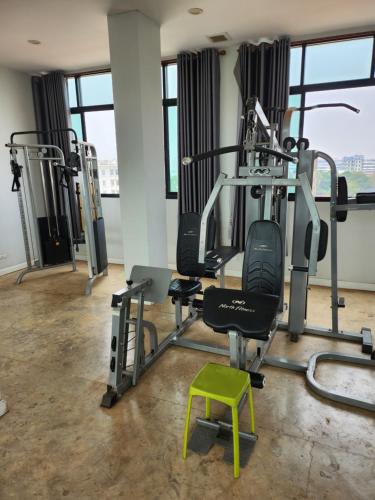 a gym with tread machines and a green stool at PND apartment 코너룸 한국식 콘도 in Vientiane