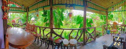 a house with a large window with plants in it at A. Zaragosa Lodging House in Inandeng
