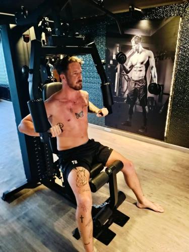 a man sitting in a chair in a gym at Blue Wild - Yala - Plastic Free & Sustainable in Tissamaharama