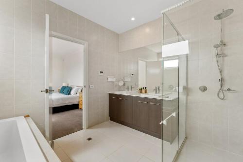 a bathroom with a shower and a sink and a toilet at Amazing Lake View family-friendly Holiday Home in Cheltenham