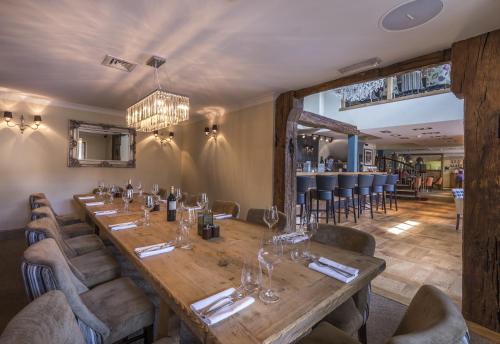 a dining room with a long table and chairs at The Three Swans Hotel, Market Harborough, Leicestershire - The Coaching Inn Group in Market Harborough