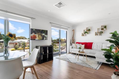 a living room with a white couch and a fireplace at Lovely Renovated 2BR Townhouse WiFi Parking in Sturt