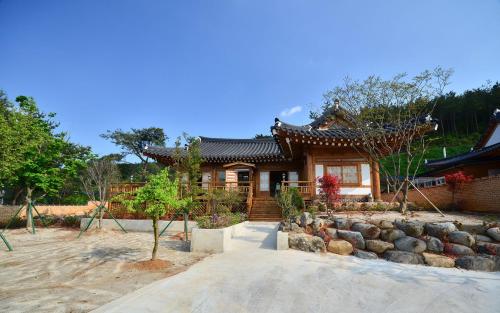 a house with a garden in front of it at Yeosu Hanulchaeok Pension in Yeosu